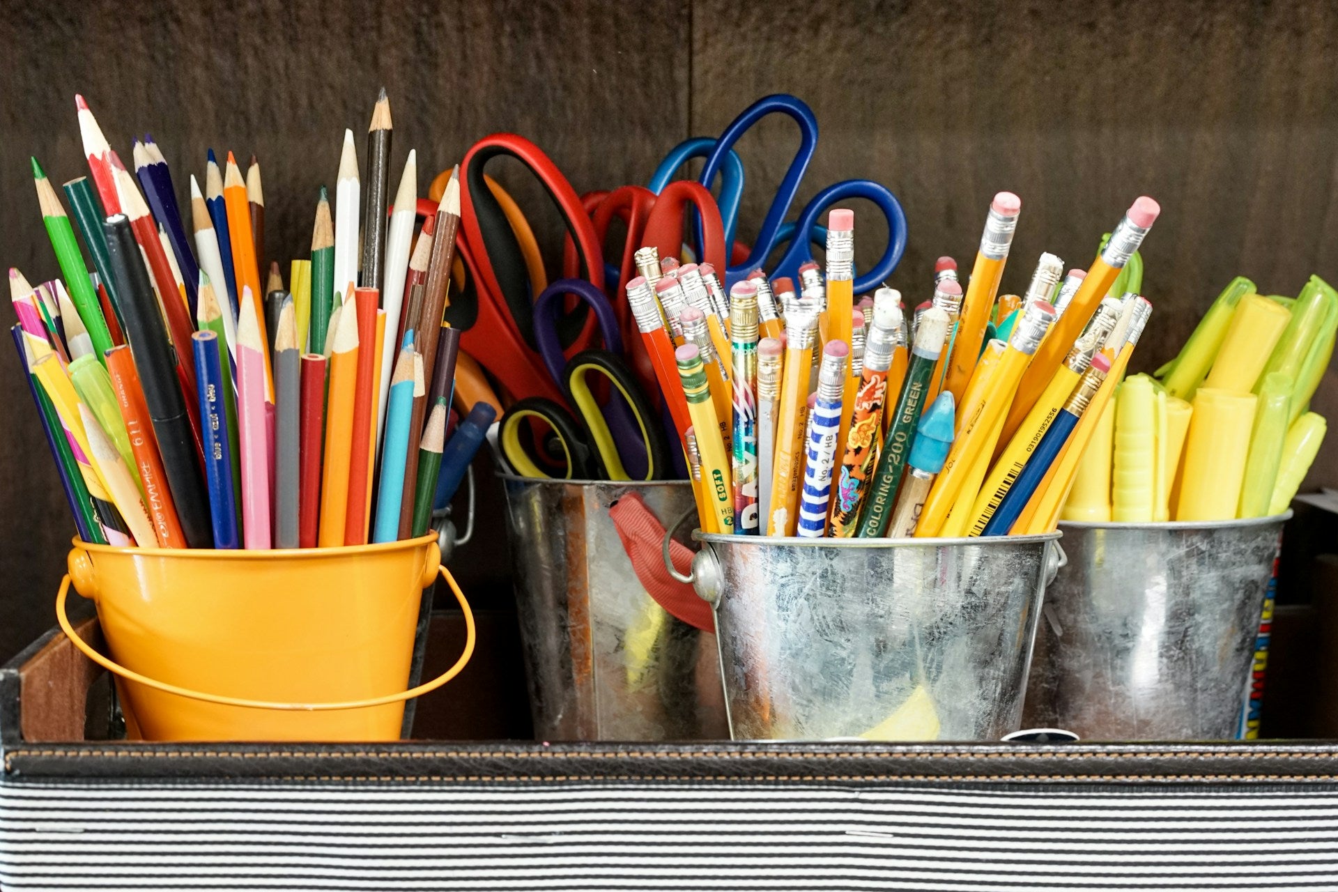 Cute school supplies that include colored pencils, pencils, highlighters, and scissors.